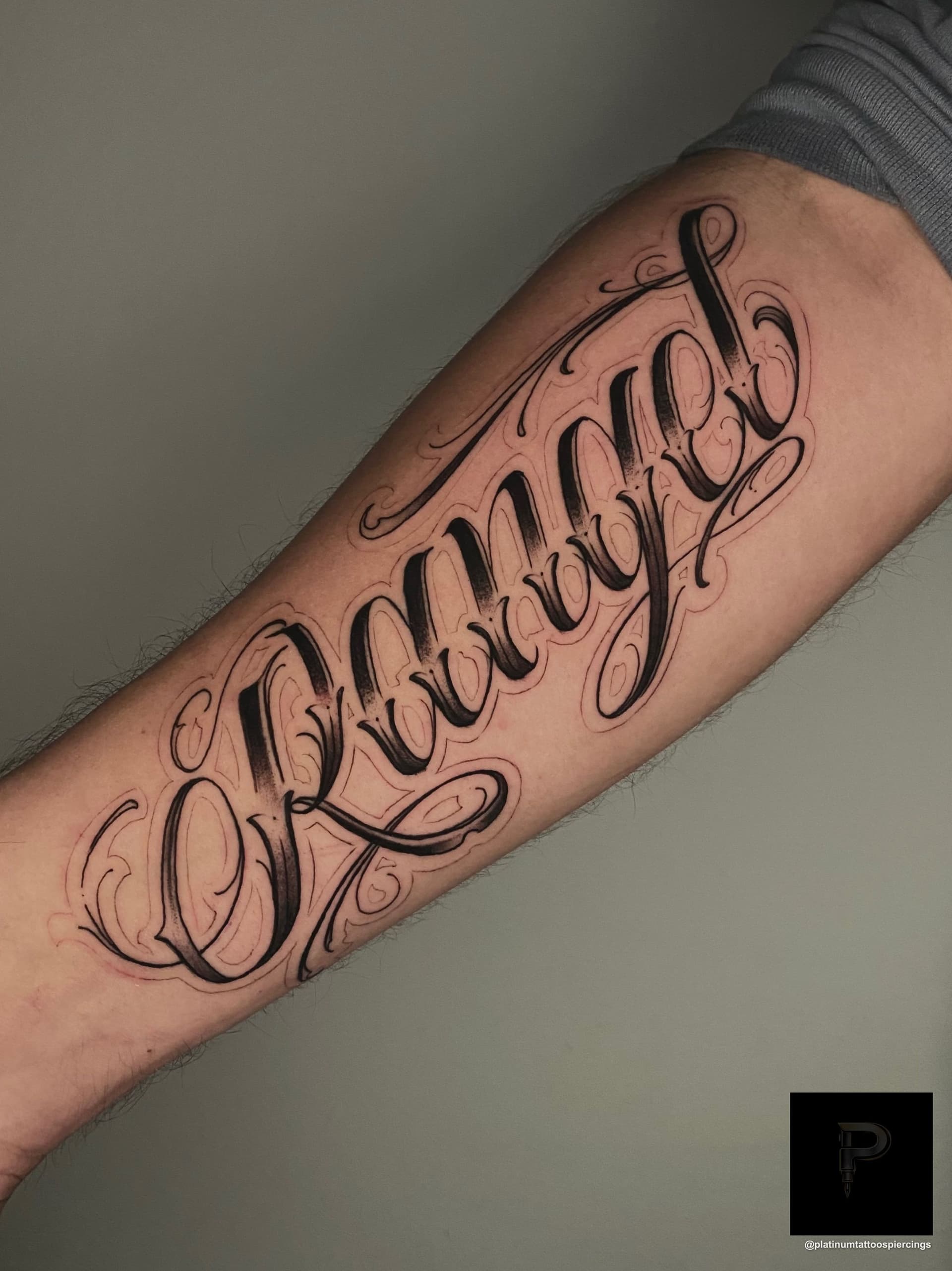 Lettering tattoo on the forearm by Remy at Platinum Tattoos & Piercings, San Antonio TX