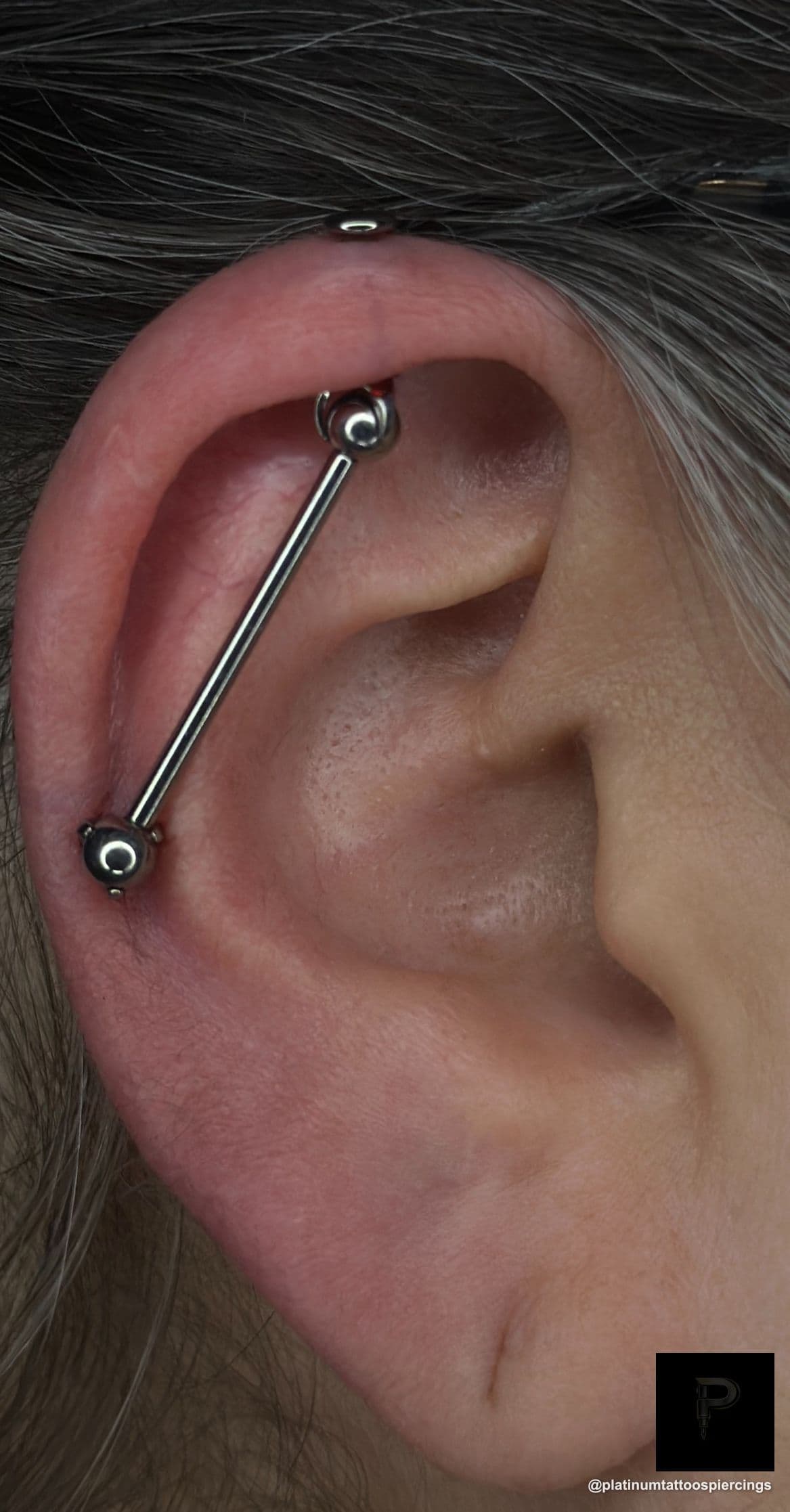 Piercing on the back by Noah at Platinum Tattoos & Piercings, San Antonio TX