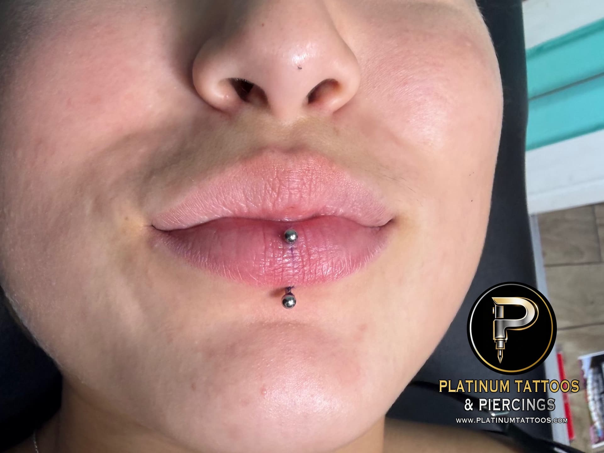 Curved Barbell piercing on the Vertical Labret by Mingo at Platinum Tattoos & Piercings, San Antonio TX